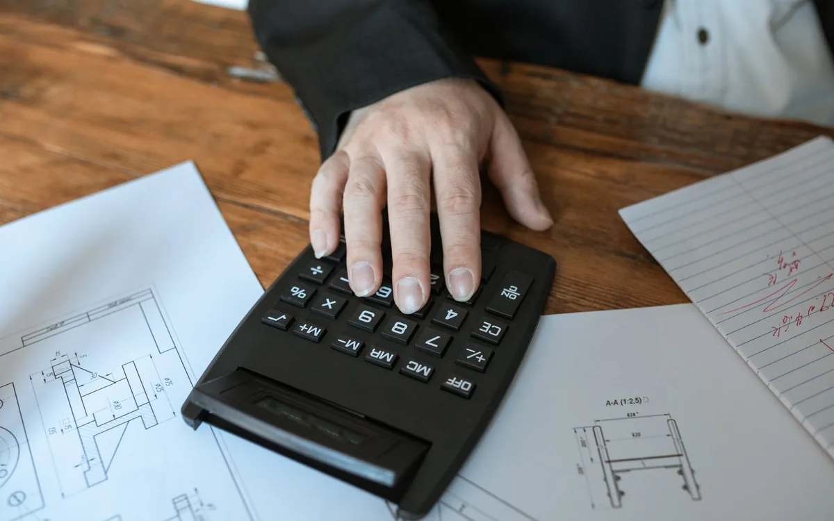 A calculator resting on medical bills and accident paperwork
