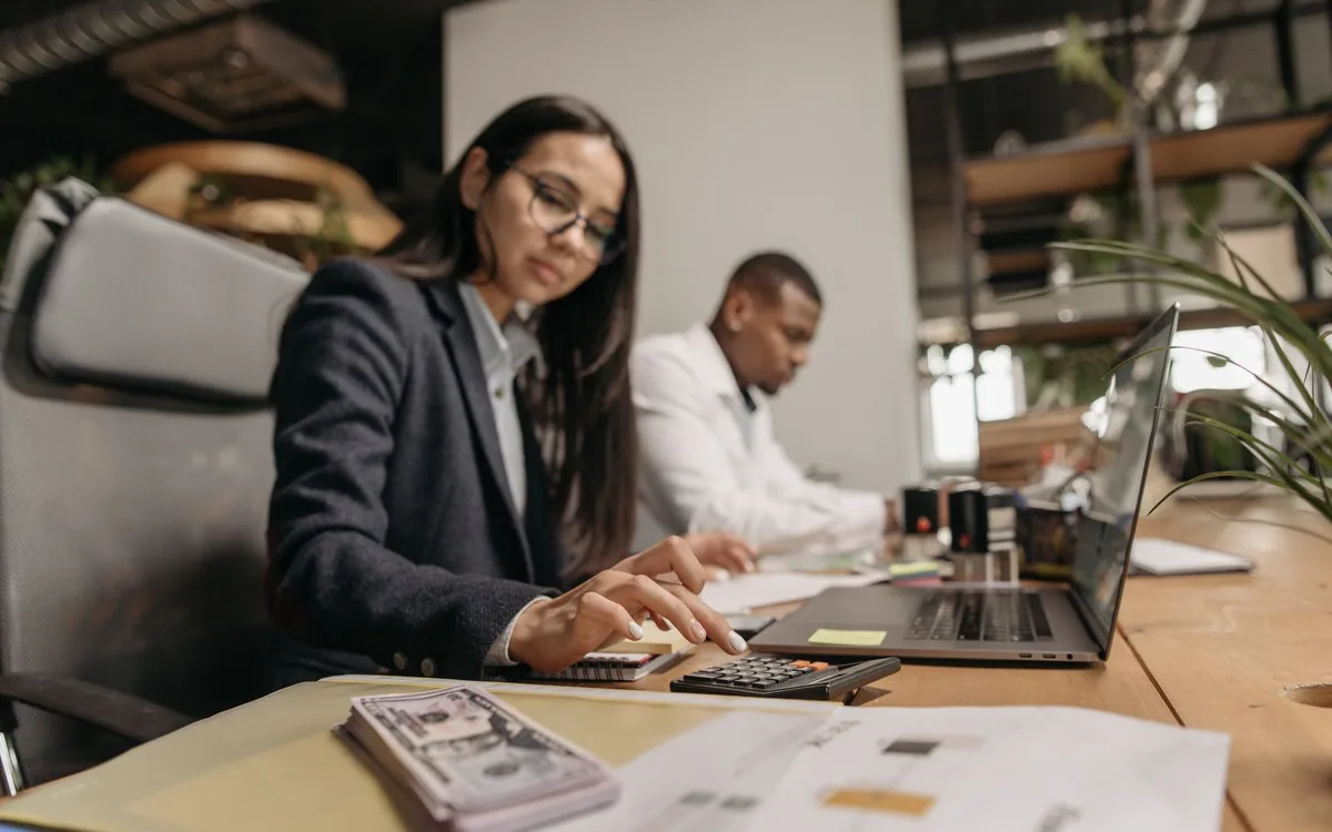 Two professionals reviewing accident claim documents at a desk