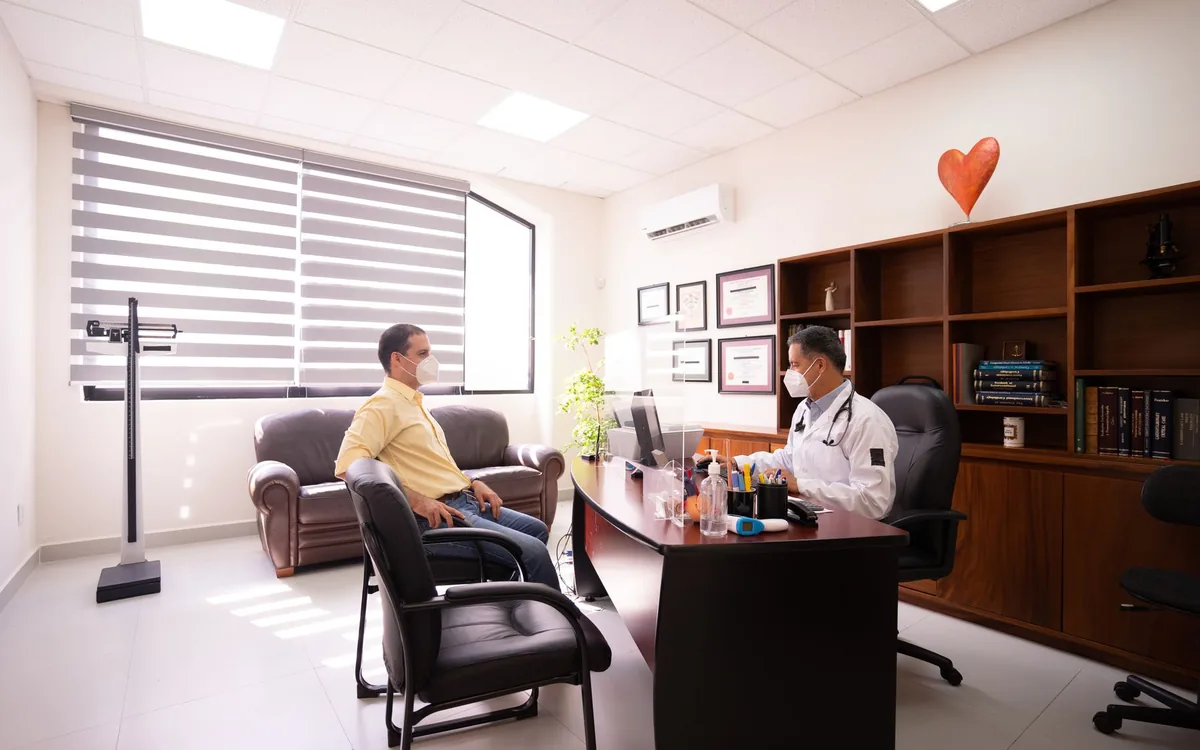 A patient speaking with a doctor in a consultation room